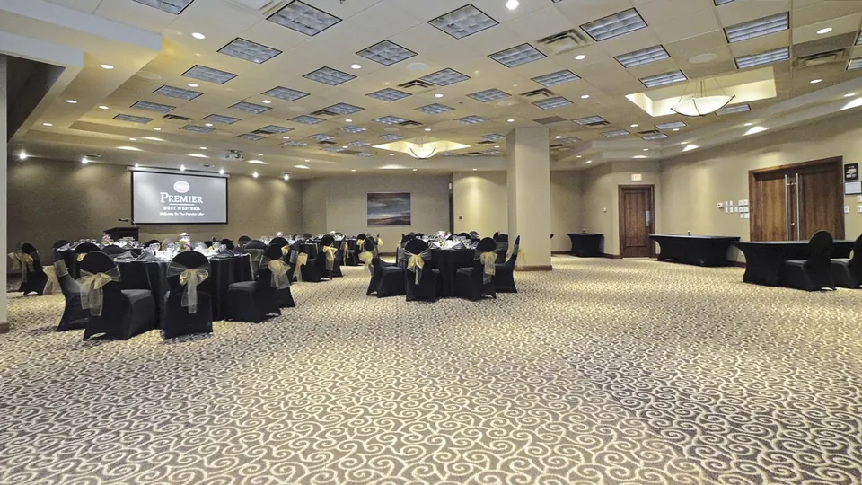 Ballroom configured for banquet with round tables and presentation screen at Chateau Granville