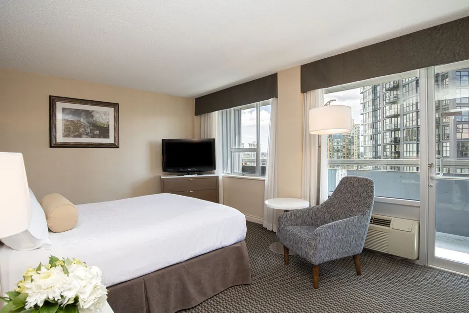 Bed in hotel room with city view