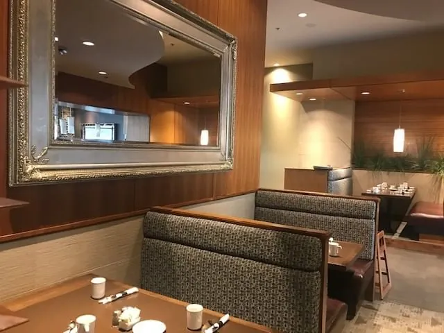 Cosy booth seating with framed mirror at The Edge Social Grille and Lounge