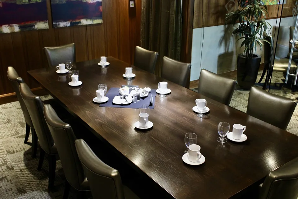 The Cambie Room boardroom table at Chateau Granville, laid with place settings along both sides