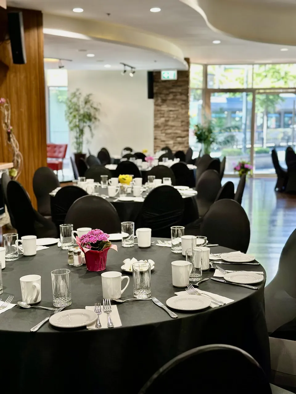 Capilano Room at Chateau Granville — a banquet table set with white place settings and a floral centrepiece