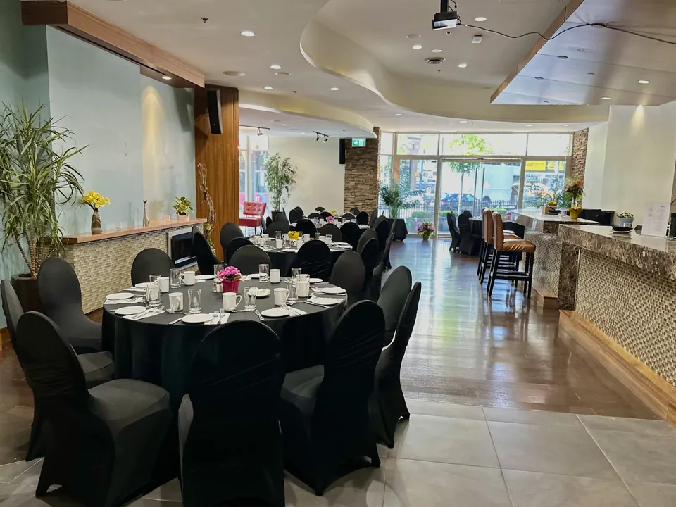 Capilano Room at Chateau Granville — banquet tables, the mosaic-tiled bar, and floor-to-ceiling windows onto Granville Street